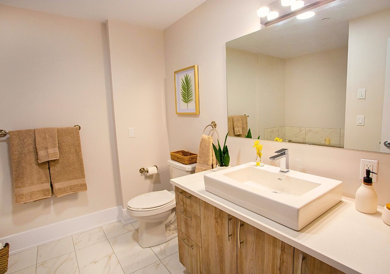 Le District  bathroom with shower and bath